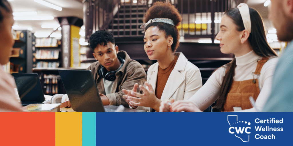 Image of students having a roundtable discussion in a library setting